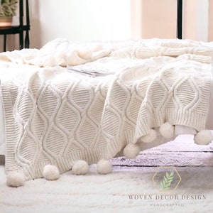 Cream knitted pom pom throw hotsell