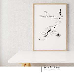 May include: A black and white map of the Florida Keys with the text "The Florida Keys" at the top. The map shows the names of the different islands and keys, including Key Largo, Marathon, Big Pine Key, and Dry Tortugas. A compass rose is in the lower right corner.