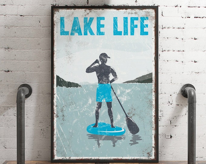 vintage "LAKE LIFE" sign , blue accent > paddleboarding poster for vintage lake house decor, male paddle boarder, modern FARMHOUSE, Canvas