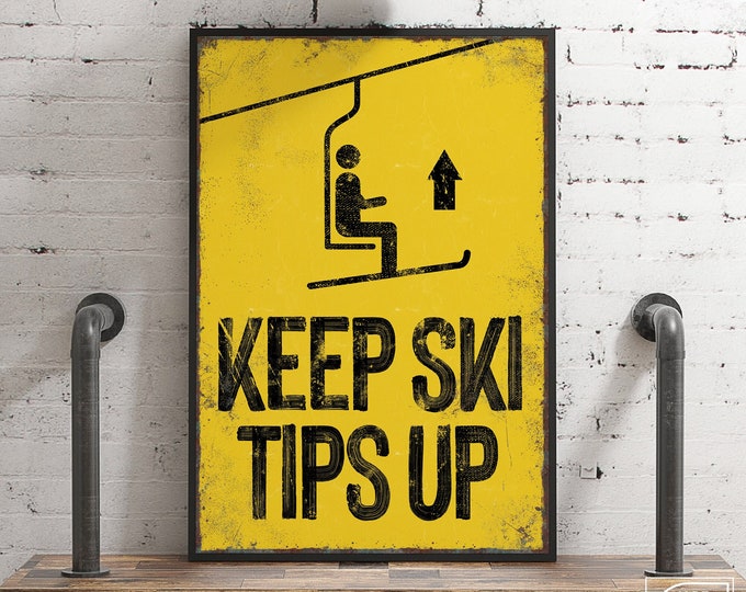 vintage yellow "Keep Ski Tips Up" sign > faux rusty edges, antique ski poster for retro mountain lodge decor, large skiing wall art