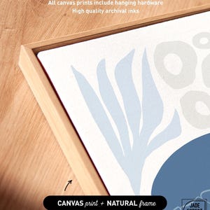 A label card for the dusty blue sea creature print set, with a canvas corner up close and a natural frame named.