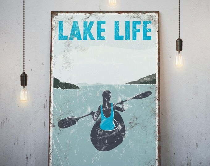 Kayak art, Lake Life sign with a female paddler and mountains, ice blue vintage print