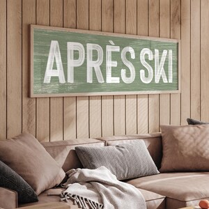 a living room with a couch and a sign on the wall