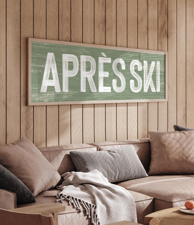 a living room with a couch and a sign on the wall
