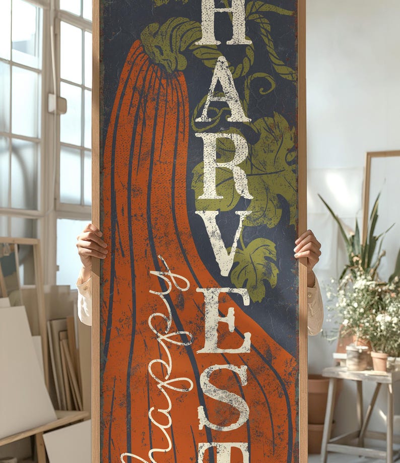 Close crop of the orange pumpkin and cream harvest letters on the deep navy ground.