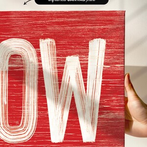 Close up of the weathered corner lettering on the barn red "Let It Snow" sign.