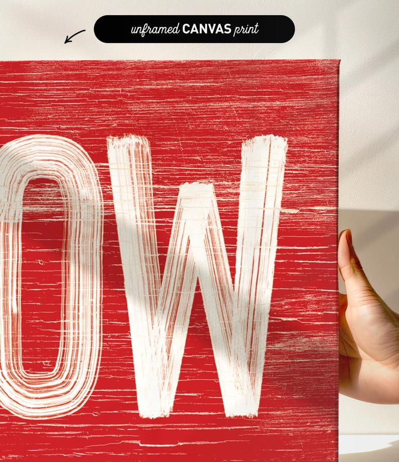 Close up of the weathered corner lettering on the barn red "Let It Snow" sign.