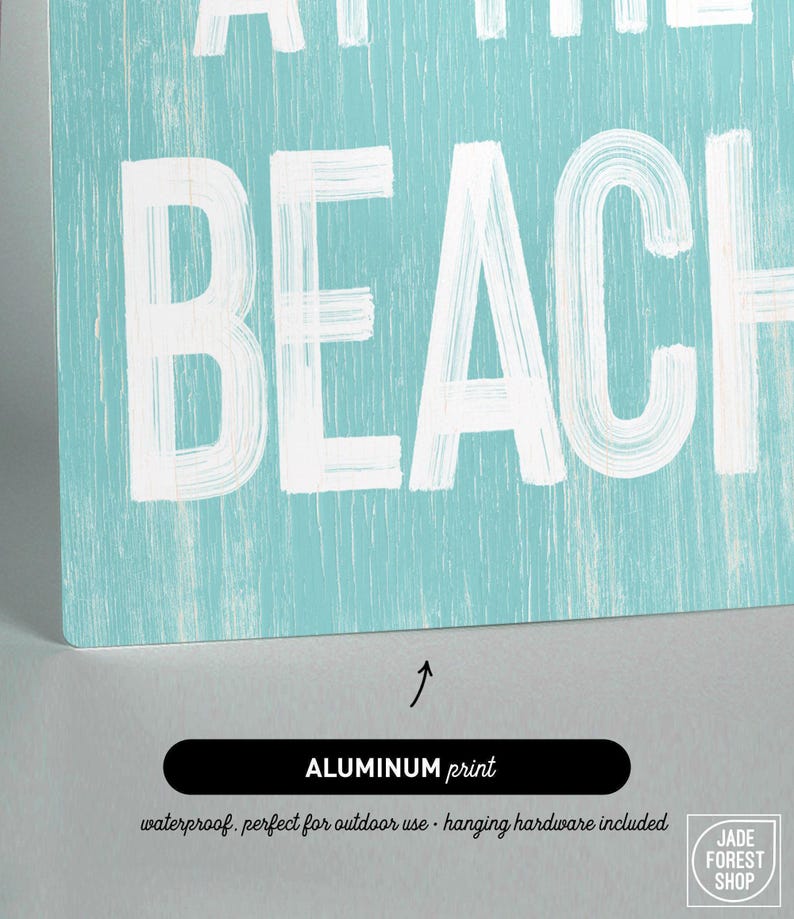 A close-up of the Meet Me At The Beach sign's lettering reading Beach, labeled as the aluminum print option.