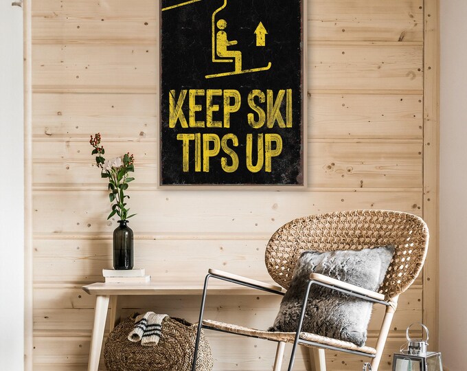 large retro "Keep Ski Tips Up" poster, black and yellow ski lift sign, faux rusty edges, antique skiing wall art for mountain lodge decor