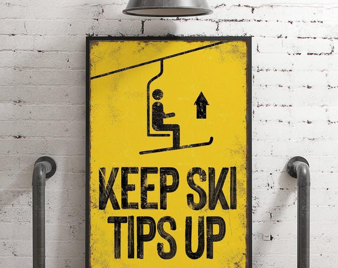 vintage yellow "Keep Ski Tips Up" sign > faux rusty edges, antique ski poster for retro mountain lodge decor, large skiing wall art