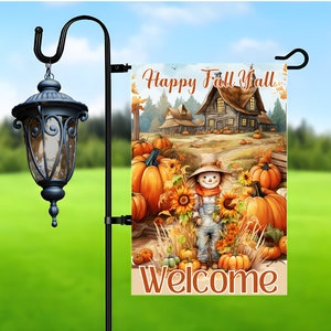 May include: A colourful autumn-themed garden flag featuring a scarecrow, pumpkins, sunflowers, and a house. The flag reads "Happy Fall Y'all" and "Welcome".