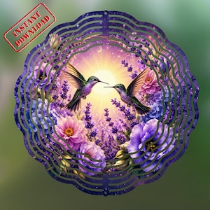 May include: A circular metal wind spinner featuring a vibrant scene of two hummingbirds facing each other amidst a field of purple lavender and pink flowers, set against a bright sunlit sky with a crescent moon and a deep purple border.
