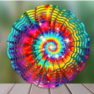 May include: A colorful tie-dye wind spinner with a spiral design and glitter accents. The wind spinner has multiple layers and is made of metal.