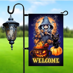 May include: A Halloween-themed garden flag with a blue-skinned witch holding a pumpkin, a black cat sitting on a pumpkin, and a cauldron with flames. The flag has a dark blue background with a full moon and stars. The text "WELCOME" is written in yellow at the bottom of the flag.