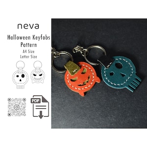 May include: Halloween keyfobs in orange, teal, and green leather with silver key rings. One is a jack-o'-lantern, and the other is a skull. The image also includes a pattern for the keyfobs, with the text "neva Halloween Keyfobs Pattern A4 Size Letter Size".