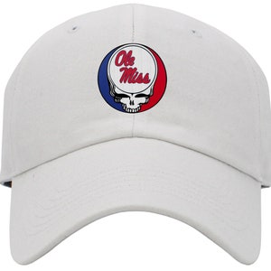 May include: White baseball cap with a red, white, and blue circular patch featuring a skull and crossbones design and the text "Ole Miss".