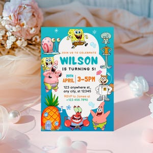 May include: A vibrant invitation card with cartoon characters. The card has a turquoise background with the text "WILSON IS TURNING 5!" and event details. Various cartoon characters are displayed around the invitation, perfect for a child's birthday party.
