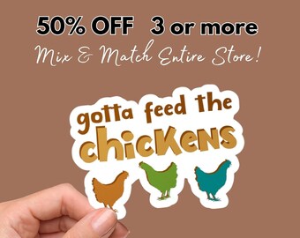 May include: A white sticker with the text "gotta feed the chickens" in brown lettering. Three cartoon chickens are below the text, one brown, one green, and one blue.