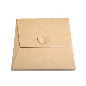 May include: A square-shaped light brown kraft paper envelope featuring a flap that secures with a die-cut heart-shaped closure. The envelope has a smooth, matte texture and a simple, clean design with a centred heart tab that folds into a slot.