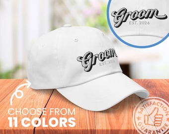 May include: White baseball cap with black embroidered text that reads "Groom Est. 2024".