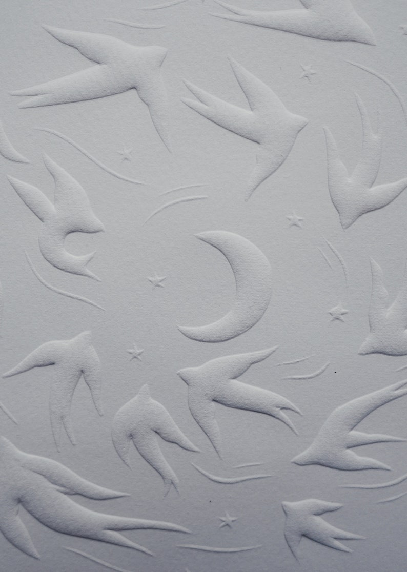 May include: A textured, off-white surface featuring an embossed pattern of swallows, stars, and a crescent moon. The design has a subtle, three-dimensional effect, creating a celestial theme.