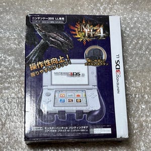 May include: A white Nintendo 3DS LL console with a Monster Hunter 4: Ultimate game cartridge inserted. The console is attached to a black and white grip accessory. The box features a black and white monster with the text "Monster Hunter 4" and "NINTENDO 3DS LL" in Japanese.