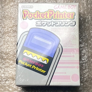 May include: A sealed Nintendo Game Boy Pocket Printer box. The box features the Game Boy logo, the product name in English and Japanese, and a graphic of the printer. The packaging is white with pink accents.