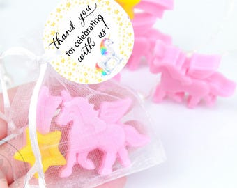 May include: Pink unicorn and yellow star-shaped soaps in a sheer bag with a "Thank you for celebrating with us!" sticker. Additional pink unicorn soaps are visible in the background. The soaps are likely handmade.
