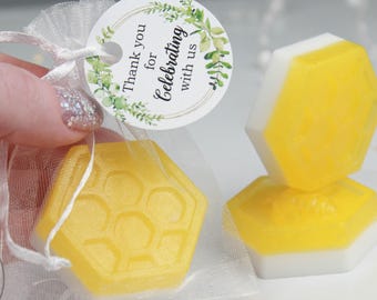 May include: Honeycomb-shaped soaps with a yellow and white design. One soap is in a sheer white bag, and two are stacked. A tag reads "Thank you for Celebrating with us."