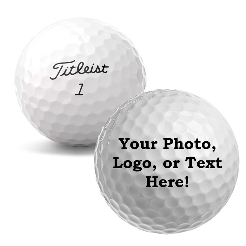 May include: Two white golf balls, one with the text "Titleist 1" and the other with the text "Your Photo, Logo, or Text Here!"