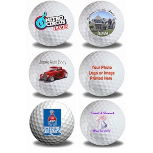 May include: Six white golf balls with different designs printed on them. The designs include a logo for Nitro Circus Live, a house with the text "Welcome to the House of Jemm", a red car with the text "Jones Auto Body", a generic placeholder for a photo or logo, a logo for Sherwin Williams, and a wedding-themed design with the text "David & Hannah May 1st 2017".