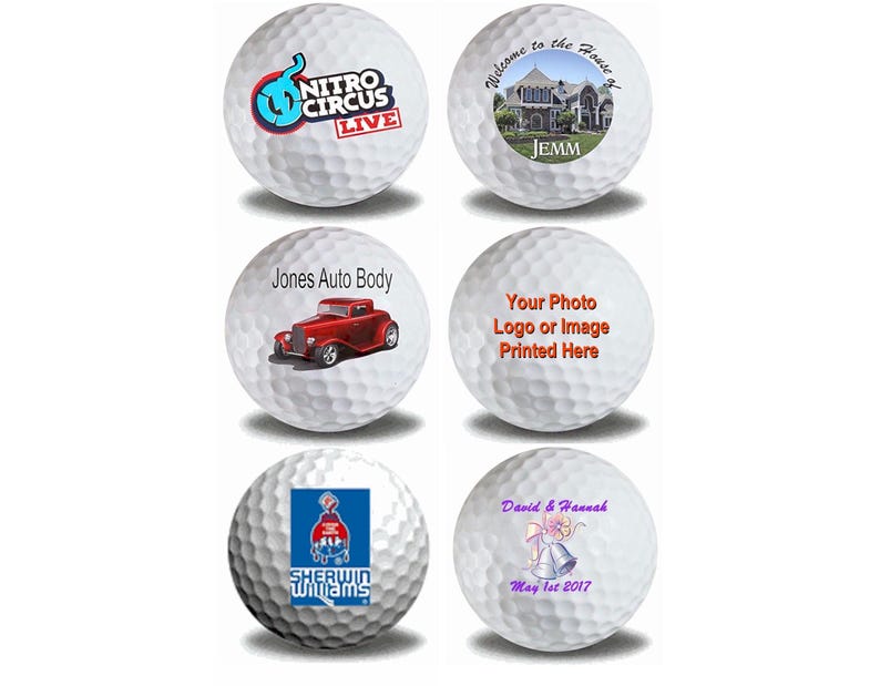 May include: Six white golf balls with different designs printed on them. The designs include a logo for Nitro Circus Live, a house with the text "Welcome to the House of Jemm", a red car with the text "Jones Auto Body", a generic placeholder for a photo or logo, a logo for Sherwin Williams, and a wedding-themed design with the text "David & Hannah May 1st 2017".