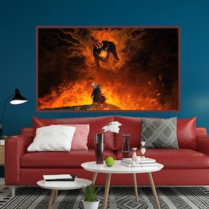 May include: A red leather sofa with white and gray pillows in front of a blue wall. A large framed print of a fiery landscape with a figure standing in the foreground hangs above the sofa.