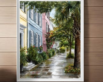May include: Watercolor painting of a street scene with colorful houses in yellow, blue, and pink. A palm tree and lush greenery line the sidewalk, which reflects the wet pavement. The artwork is framed in white.