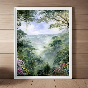 May include: A framed watercolor painting of a lush rainforest scene. A suspension bridge spans the misty valley, surrounded by vibrant green foliage, colorful flowers, and tall trees. The artwork is set in a white frame.