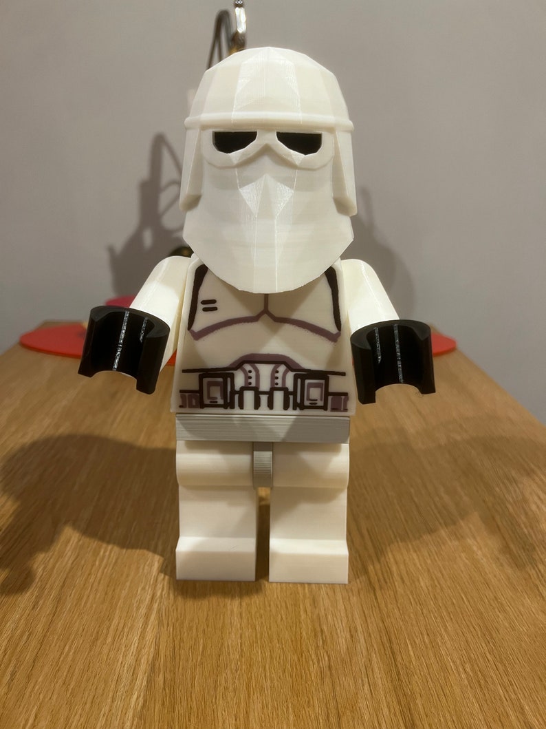 May include: White Lego minifigure of a Star Wars Stormtrooper with a black helmet and black hands.
