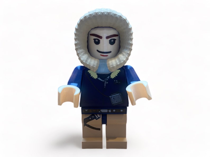May include: A Lego minifigure of a person wearing a blue jacket with a fur-lined hood. The figure has tan legs, light tan hands, and a small bag. The figure is standing against a white background.