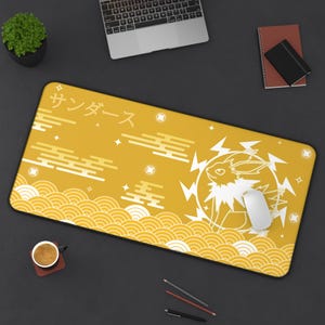 May include: A yellow mousepad with a white outline of a Pokemon character and the Japanese text "サンダース" (meaning "Thunder" in English). The mousepad has a wave pattern and a black border.