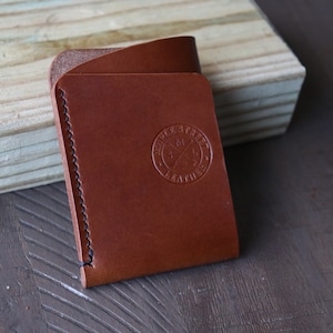 Handmade and hand stitched whiskey Buttero leather card wallet. One card pocket (fits many cards) and one folded cash flap.