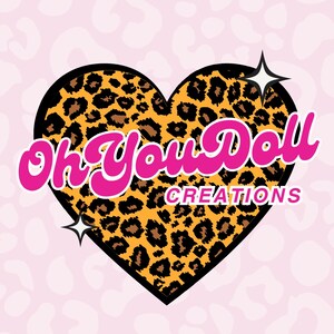 May include: A logo design featuring a heart-shaped leopard print pattern with a black border. The text "Oh You Doll" is in pink script, and "CREATIONS" is in a smaller font. Two white starbursts are on either side of the heart, set against a pink background.