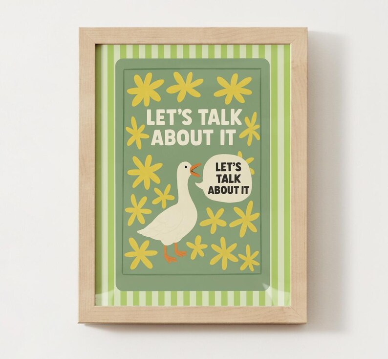 May include: A framed art print featuring a white goose with an open beak, surrounded by yellow flowers. The text "LET'S TALK ABOUT IT" is displayed in a speech bubble and above the goose. The background is green with a striped border.