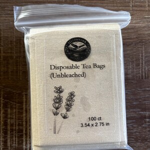 May include: A clear plastic resealable bag containing a stack of unbleached disposable tea bags. The label features the Yellowhawk Botanicals logo, the text "Disposable Tea Bags (Unbleached)", a lavender illustration, 100 ct, and 3.54 x 2.75 in.