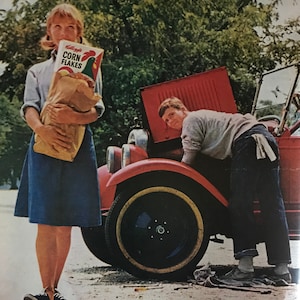 May include: Vintage advertisement featuring a woman holding a Kellogg's Corn Flakes box and a man working on a red car. The ad includes text that reads "In the spring a young man's fancy lightly turns to thoughts of Kellogg's Corn Flakes."