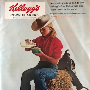 May include: Vintage Kellogg's Corn Flakes advertisement featuring a woman in a cowboy hat and boots pouring milk into a bowl of cereal. The ad includes the Kellogg's logo and the text "Corn Flakes". A box of Corn Flakes is visible.