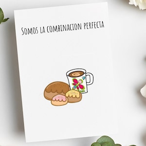 May include: White card with the text "SOMOS LA COMBINACION PERFECTA". The card features an illustration of a coffee mug with a butterfly design, and three baked goods. The image is set against a white background with floral accents.