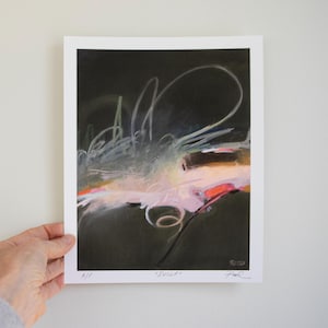 May include: An abstract art print titled "Reset" featuring a dark black background with expressive white, pink, and orange brushstrokes. The print includes the text "A/P" on the bottom left, "Reset" in the center, and a signature on the bottom right.