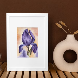 May include: A framed watercolor painting of a purple iris flower with water droplets on the petals. The painting is set against a yellow and orange background.
