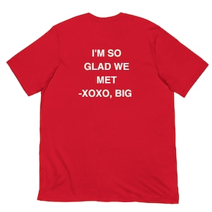 Pode incluir: Camiseta vermelha com texto branco que diz "I'm so glad we met -XOXO, Big"