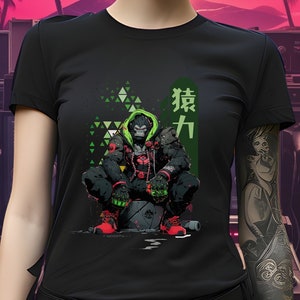 May include: Black t-shirt with a green and red illustration of a gorilla wearing a hooded jacket and holding a weapon. The Japanese text "猿力" is printed on the shirt.