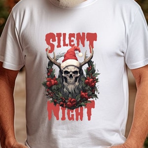 May include: White t-shirt featuring a red and black skull wearing a Santa hat and a wreath of holly and red roses. The text "Silent Night" is written in red below the skull.